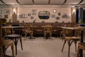 a restaurant with tables and chairs and a bench at Hotel Niles Istanbul in Istanbul