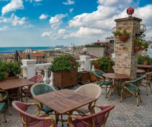 a patio with tables and chairs on a roof at Hotel Niles Istanbul in Istanbul