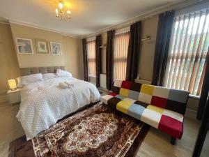 a bedroom with a bed and a bench in it at E-Sky Homes in South Norwood