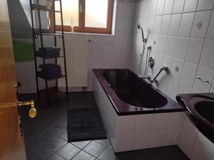 a bathroom with a purple tub and a sink at Zuhause in Hofs ,Leutkirch im Allgäu in Leutkirch im Allgäu