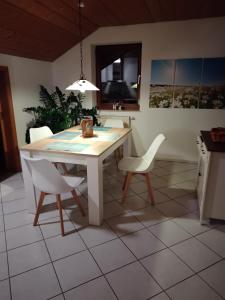 a kitchen with a table and two chairs and a table at Zuhause in Hofs ,Leutkirch im Allgäu in Leutkirch im Allgäu