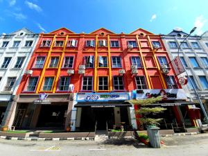 a large colorful building on a city street at Good2Stay Hostel in Melaka