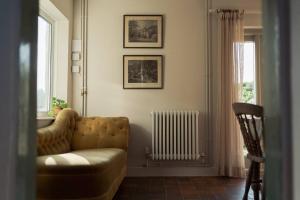 a living room with a couch and a radiator at The Walled Garden in Totnes