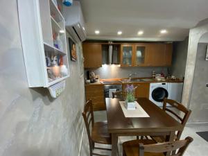 a kitchen with a wooden table and a dining room at Casa Sofia in Naples