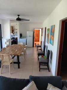 a dining room and living room with a table and chairs at Newly Renovated Seaside Oasis at Bonita Village in Las Terrenas