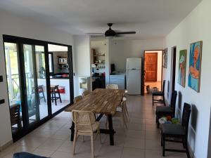 a dining room with a wooden table and chairs at Newly Renovated Seaside Oasis at Bonita Village in Las Terrenas