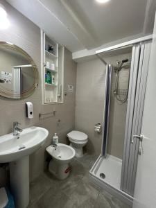 a bathroom with a sink and a toilet and a shower at Casa Sofia in Naples