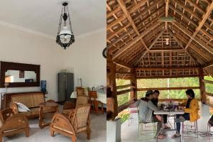 two people sitting at a table in a pavilion at Omah Pinaringan in Solo