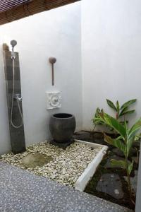 a bathroom with a shower and a toilet in a room at Omah Pinaringan in Solo