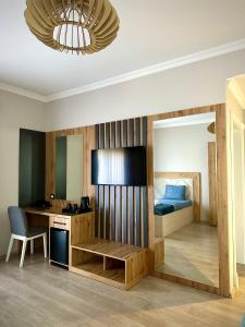a bedroom with a bed and a desk and a desk at Hotel Borea in Peje