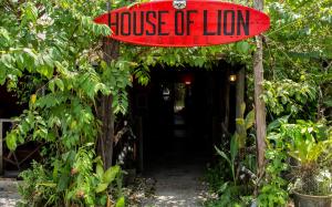a house oflion sign in front of a house oflion sidx sidx at House of Lion Hostel in Pantai Cenang