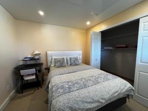 a small bedroom with a bed and a desk at citadel cozy quilt private bedroom in Calgary