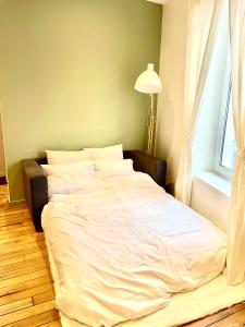 Posteľ alebo postele v izbe v ubytovaní Appartement cosy NANCY
