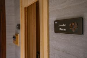 a sign on the door of a bathroom at Vivian Park El Raeid Hotel in Riyadh