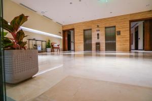 an empty lobby with a potted plant in the middle at Vivian Park El Raeid Hotel in Riyadh