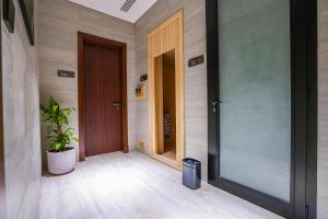 a hallway with two doors and a potted plant at Vivian Park El Raeid Hotel in Riyadh
