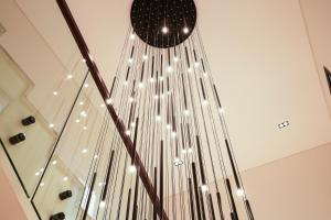 a chandelier hanging from a ceiling with lights at Vivian Park El Raeid Hotel in Riyadh