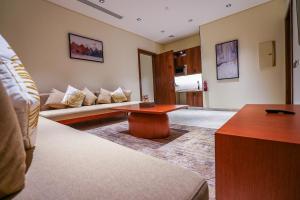 a living room with a couch and a table at Vivian Park El Raeid Hotel in Riyadh