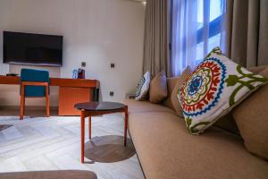 a living room with a couch and a table at Vivian Park El Raeid Hotel in Riyadh