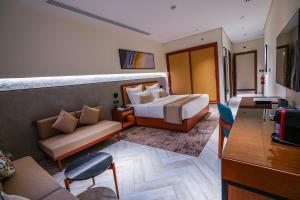 a hotel room with a bed and a couch at Vivian Park El Raeid Hotel in Riyadh