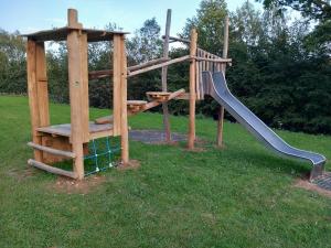 a playground with a slide in the grass at Les terrasses de Malmedy duplex 428 in Malmedy