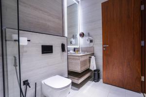 a bathroom with a toilet and a sink at Vivian Park El Raeid Hotel in Riyadh