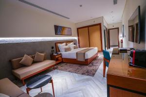 a hotel room with a bed and a couch at Vivian Park El Raeid Hotel in Riyadh