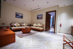 a living room with two couches and a table at Vivian Park El Raeid Hotel in Riyadh