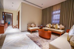 a living room with a couch and a table at Vivian Park El Raeid Hotel in Riyadh