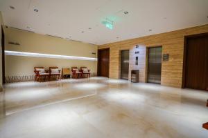 a large empty room with tables and chairs in it at Vivian Park El Raeid Hotel in Riyadh