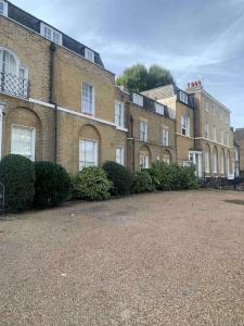 a row of brick buildings in a parking lot at Large Apartment - 20 mins to the City in London