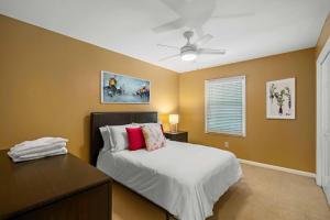 a bedroom with a bed and a desk and a ceiling fan at Townhouse in Marietta in Marietta