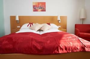 Postelja oz. postelje v sobi nastanitve City-Hotel Mödling