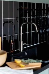 a kitchen counter with a sink and a cutting board at Appartement T3 la perle verte in Agde