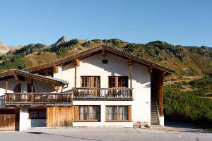 ein Haus mit einem Balkon an der Seite in der Unterkunft Alpina Holiday Living Apartments in Obertauern