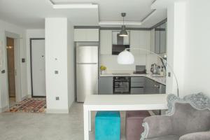 a kitchen with a white table and a couch at Seaside Serenity in Bodrum: Luxury Retreat w View in Turgutreis