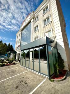 a building with a large glass door in front of it at Hotel Borea in Peje