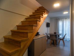 a wooden staircase in a kitchen with a table at Loretta IV in San Martín de los Andes