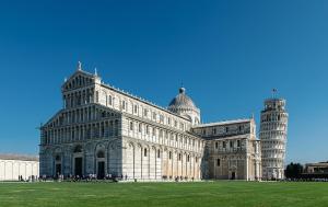 a large building with two towers in a field at Casa Vacanze Tosca 3 in Pisa