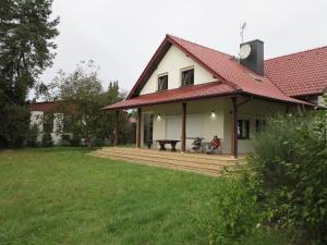 a person sitting on a porch of a house at AirSpot Balice in Cholerzyn