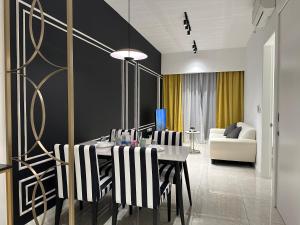 a dining room with a table and black and white chairs at The Axon Suites Bukit Bintang KLCC By SKYSCRAPER in Kuala Lumpur