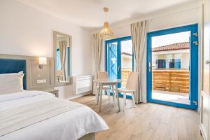 a bedroom with a bed and a table and chairs at Pensiunea Terrablue in Sulina +67 photos