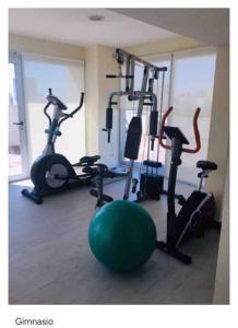 a gym with several exercise bikes and a green ball at Zona Güemes. Piscina climatizada. Hermoso 2 amb. in Mar del Plata