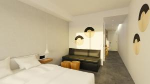 a bedroom with a white bed and a couch at Pontikonisi Hotel & Suites in Perama