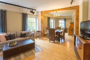 a living room with a couch and a table at Altes Fotohaus in Freyburg