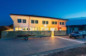 a building with a car parked in front of it at Pensiunea Terrablue in Sulina