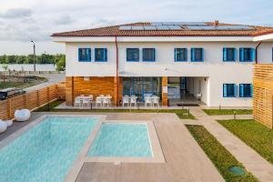 a house with a swimming pool in front of it at Pensiunea Terrablue in Sulina