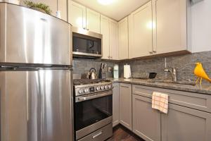 a kitchen with a stainless steel refrigerator and cabinets at Serenity Park Slope - Entire Brownstone apt. in Brooklyn