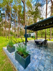 a picnic shelter with a picnic table and plants at Domek na Jurze in Kroczyce