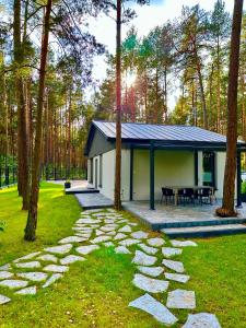 a building with a table and a stone walkway in a yard at Domek na Jurze in Kroczyce